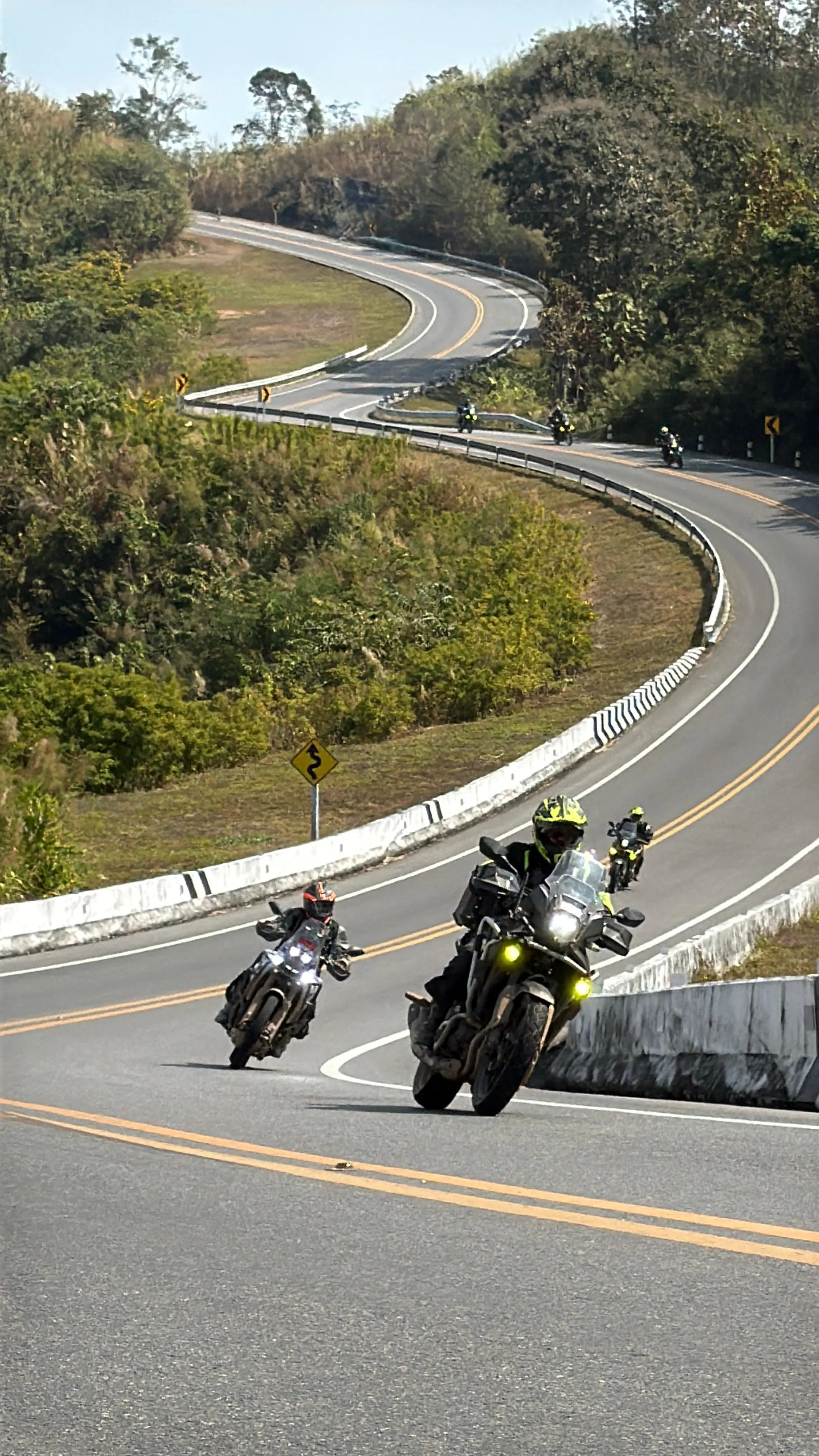 Riders coming down a winding road