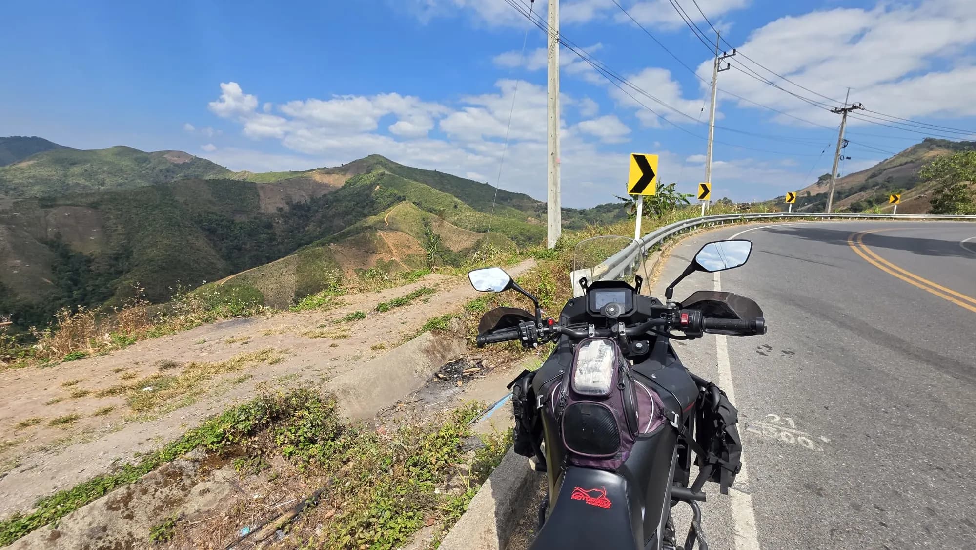 Motorcycle parked on a mountain with a scenic view