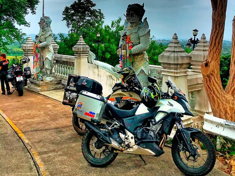 Honda CB500X parked at Buddha Hill temple with Naga statues