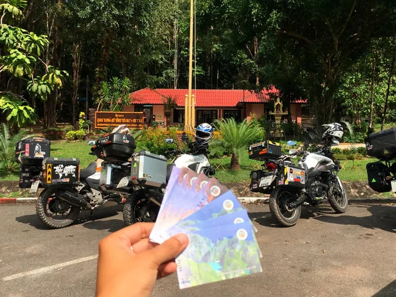 Bikes parked at a national park entrance with entry tickets