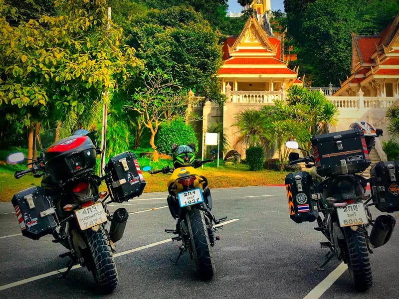 Three bikes parked at a Thai temple