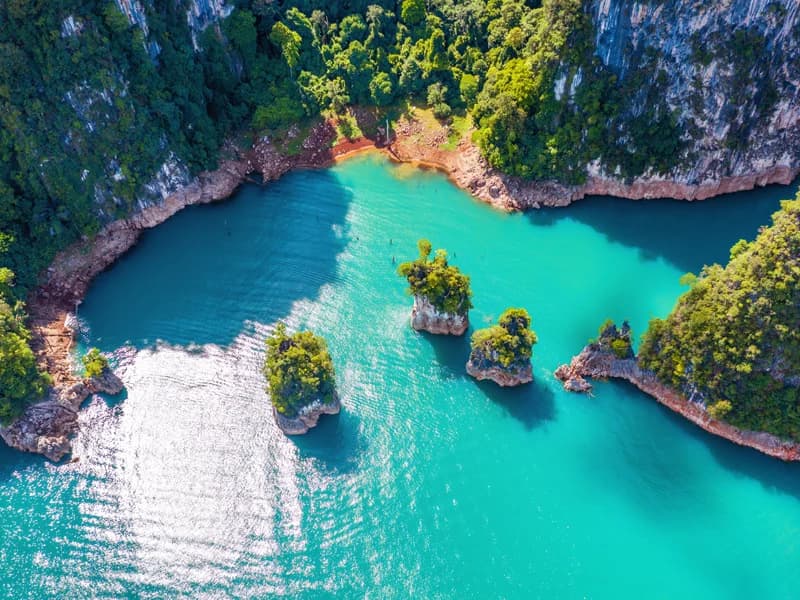 Aerial view of turquoise Cheow Lan Lake with limestone karsts in Khao Sok National Park