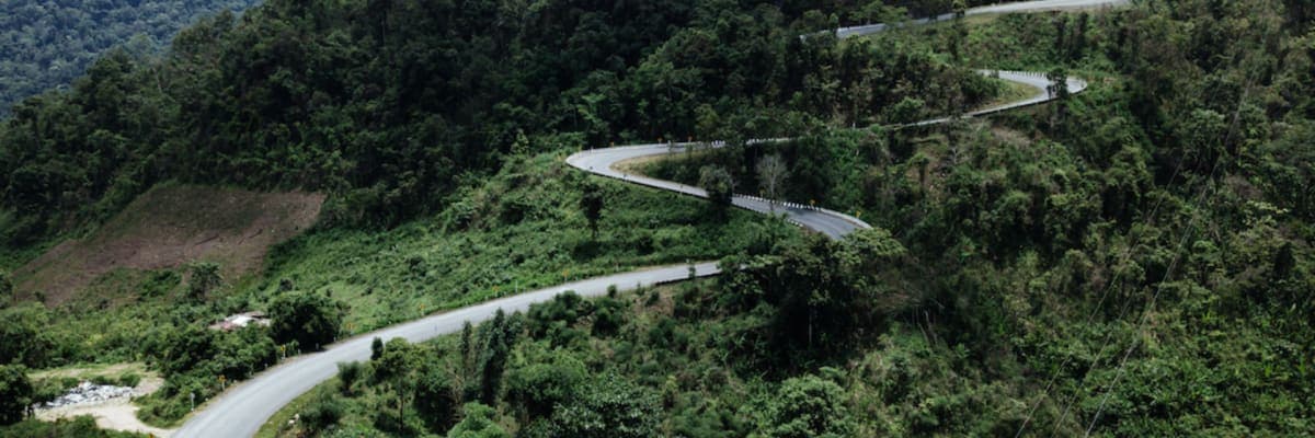 Motorcycle riders exploring a mountain trail on a Motorbike Madness Thailand tour